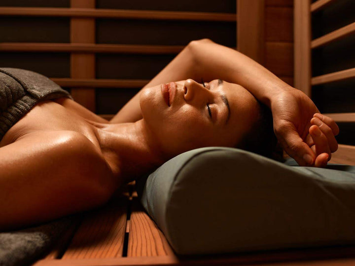 Woman laying down with eyes closed in the far infrared sauna